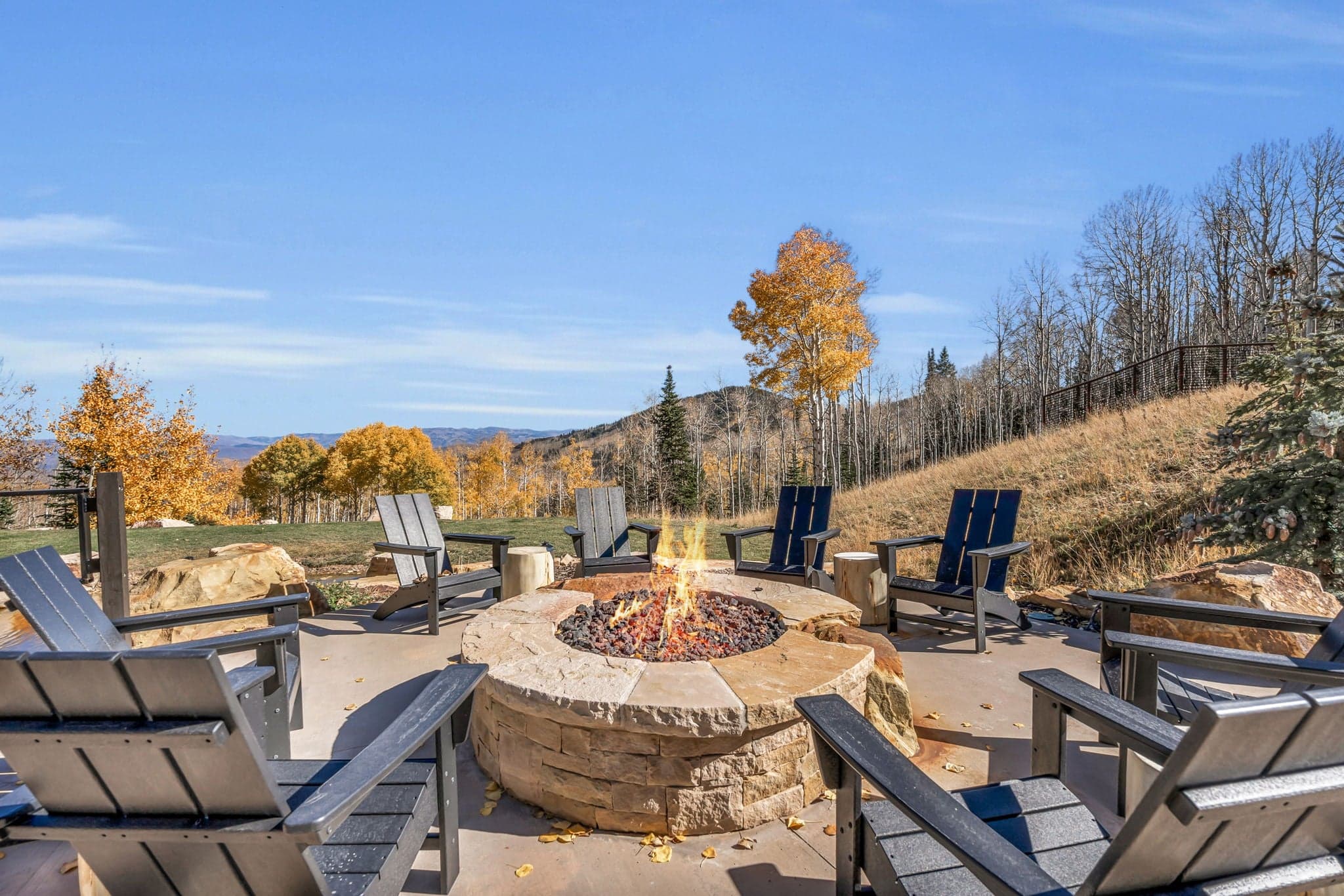 Fire Pit Surrounded by Wooden Outdoor Chairs