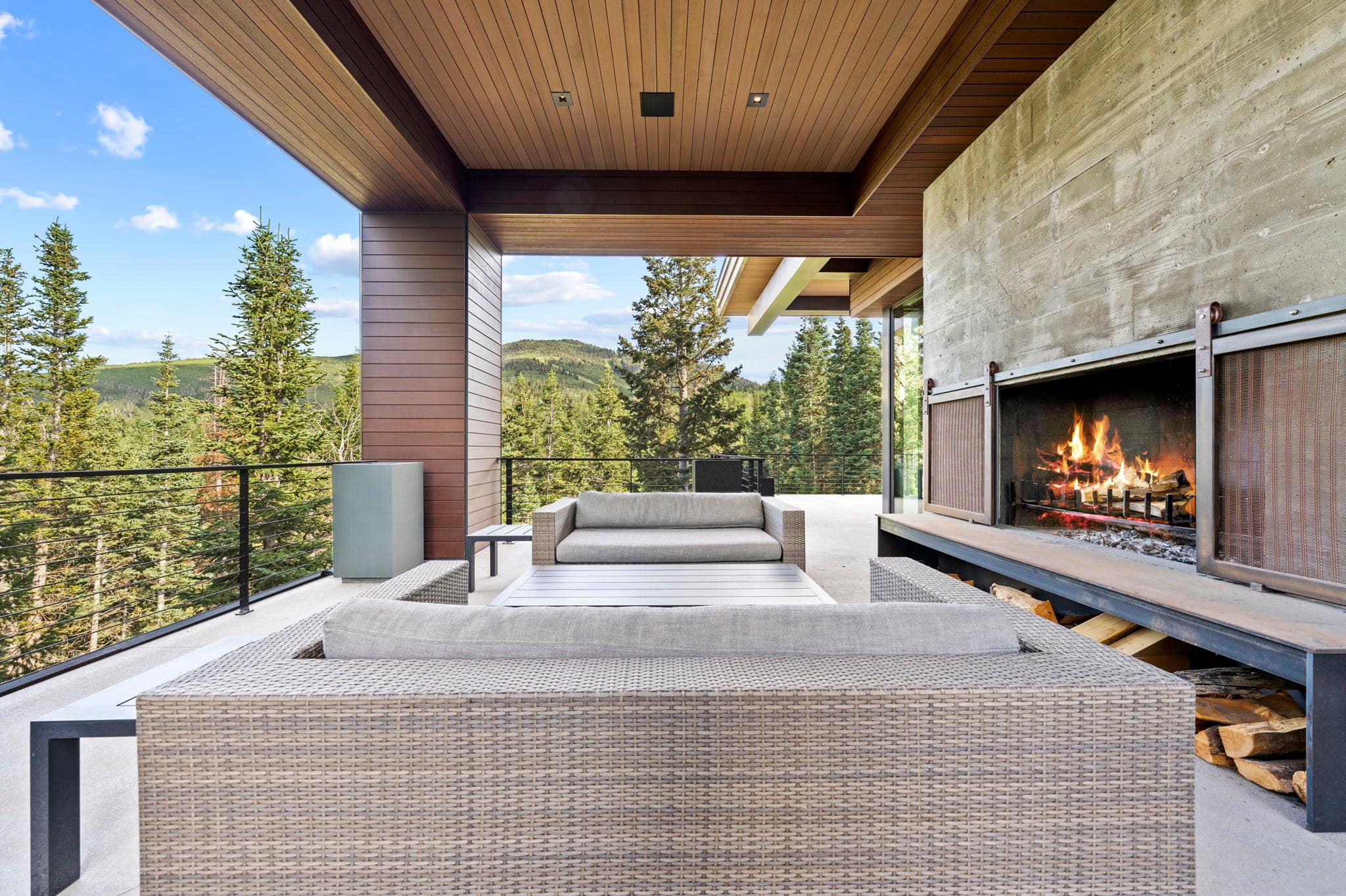 A stylish patio with a fireplace and stunning views.