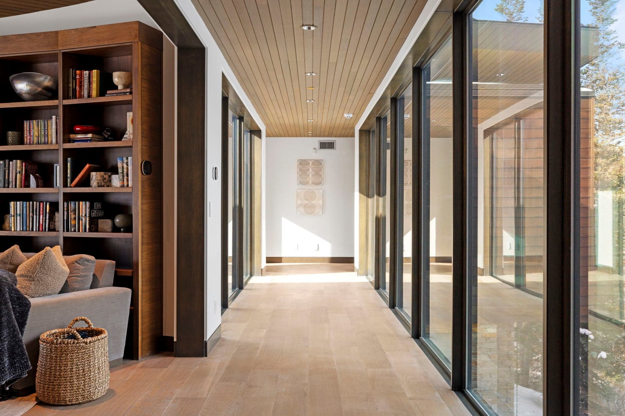 A hallway with floor-to-ceiling windows.