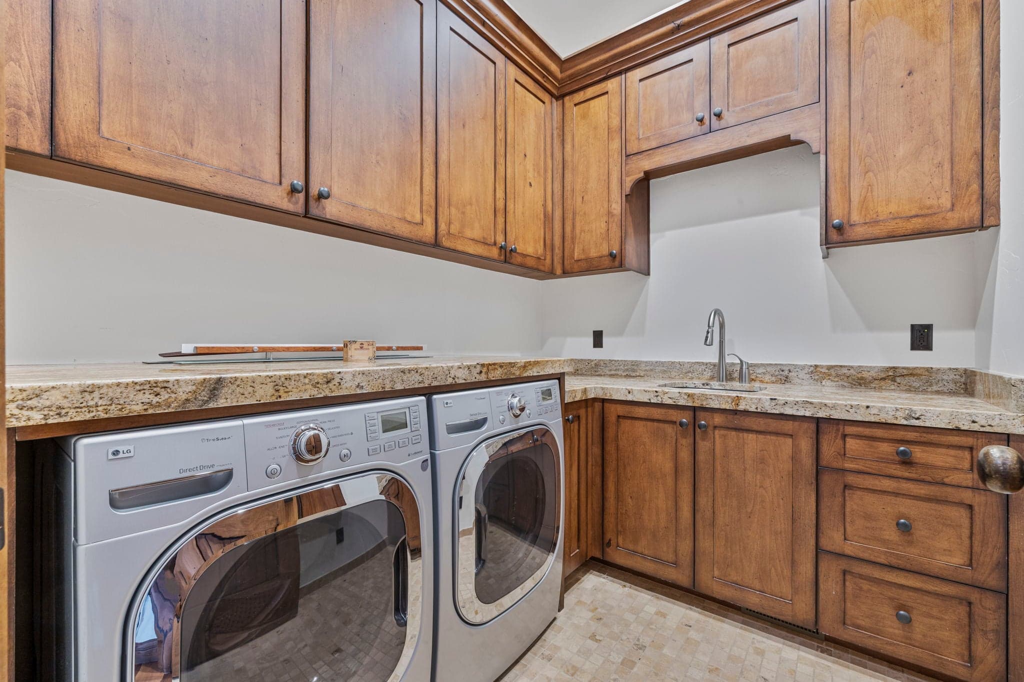 laundry room with sink and lots of storage